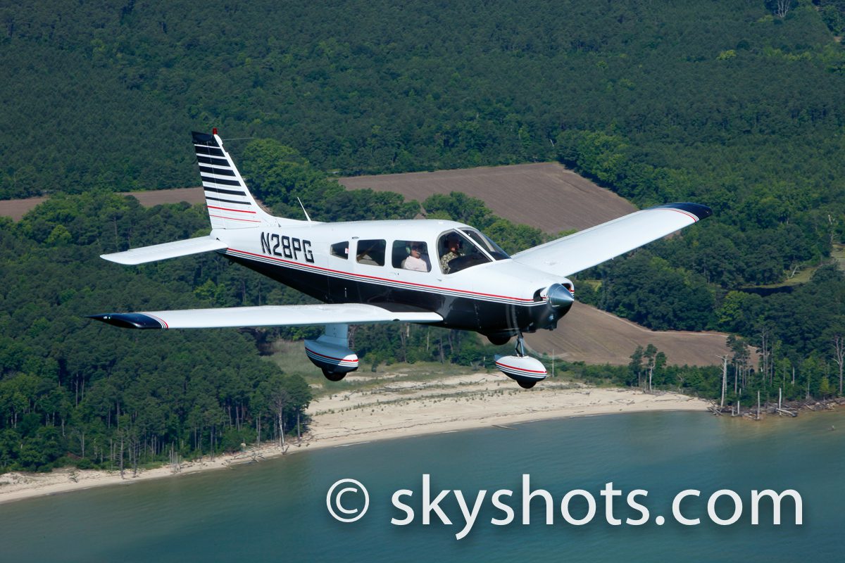 Aircraft soaring above lush landscape