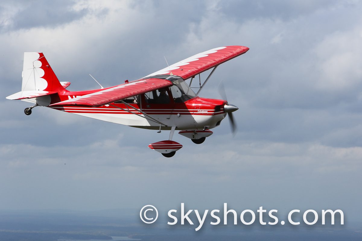 Red and white airplane flying
