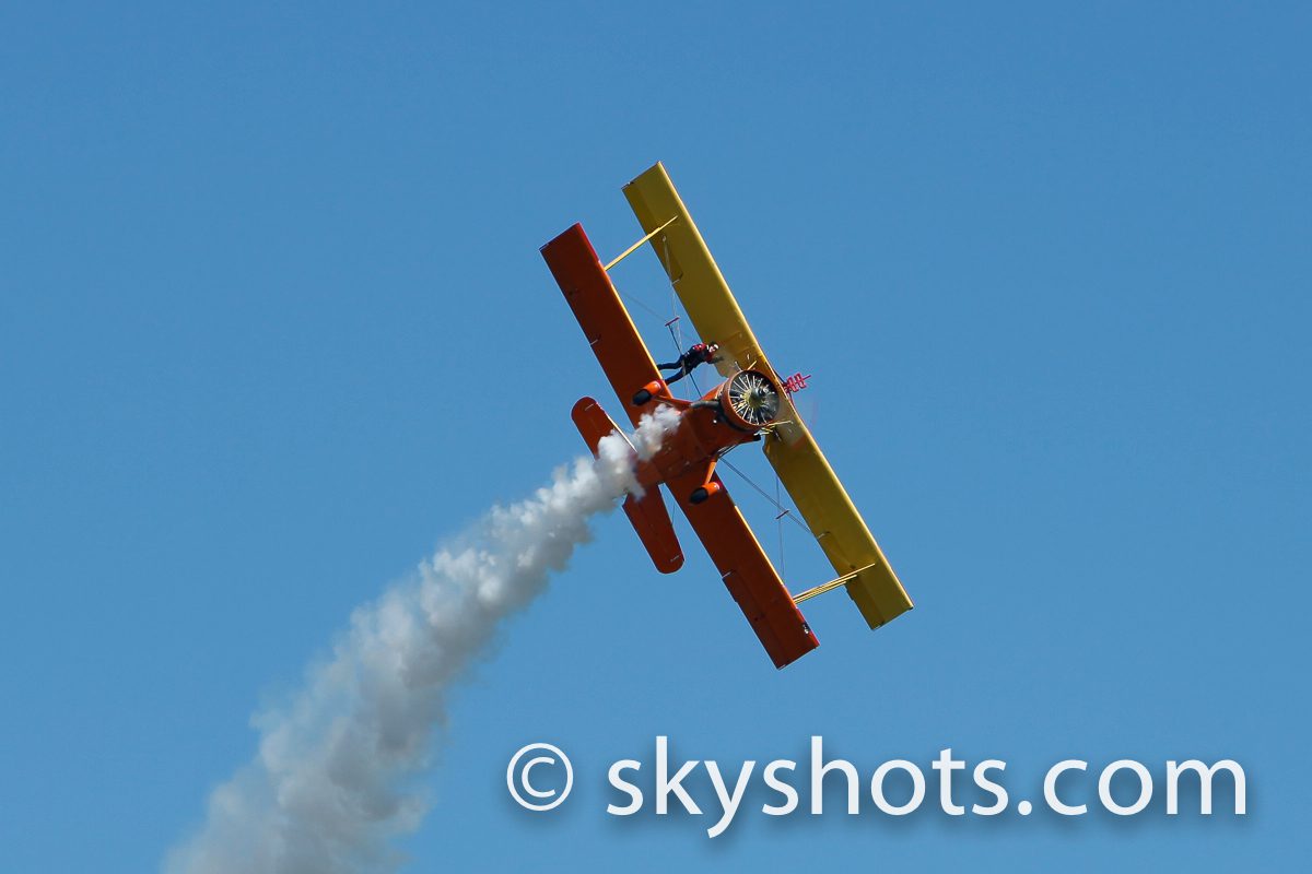 Classic biplane in mid-air maneuver