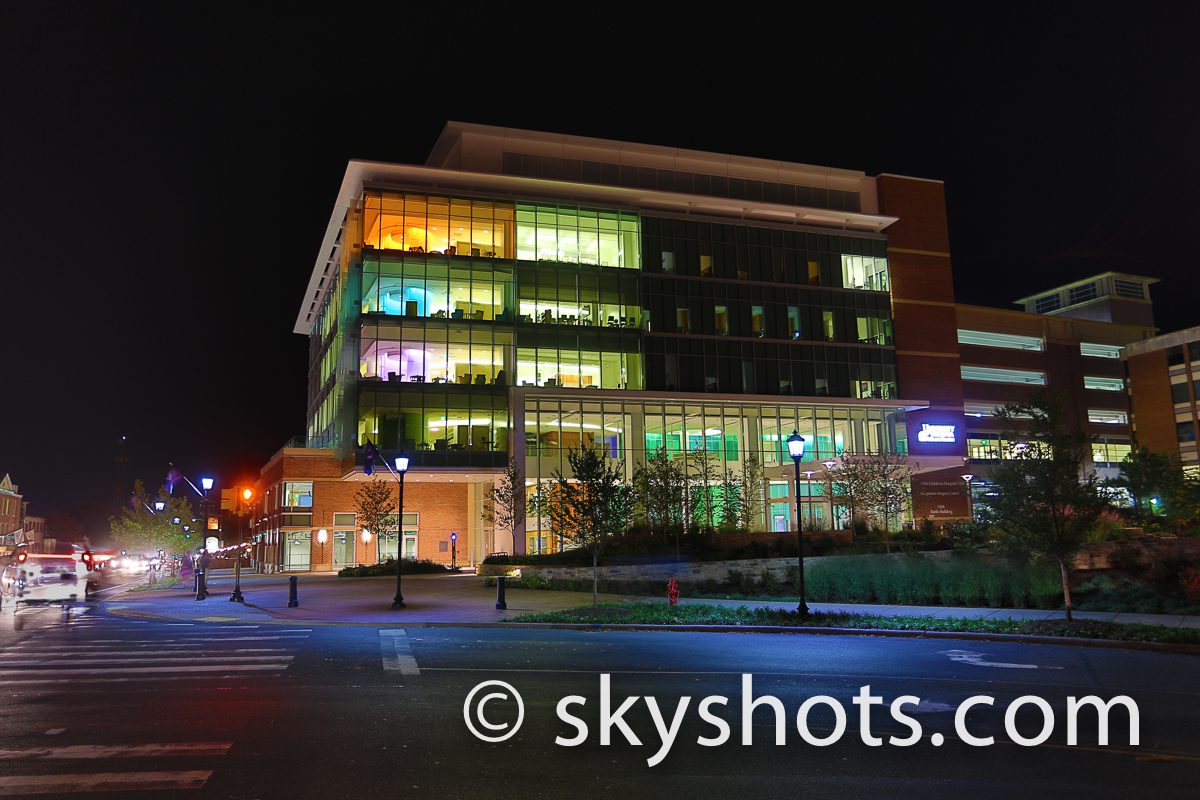 Illuminated office building by a street.