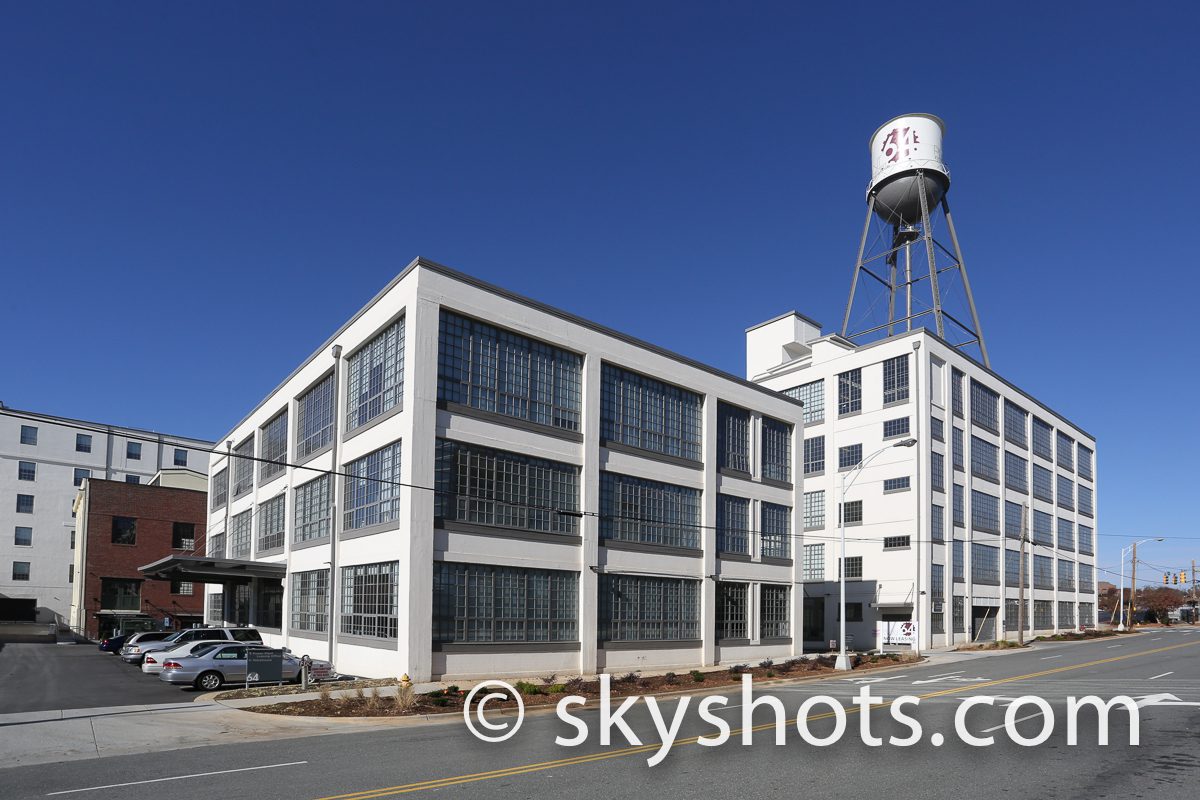 White industrial building with water tower