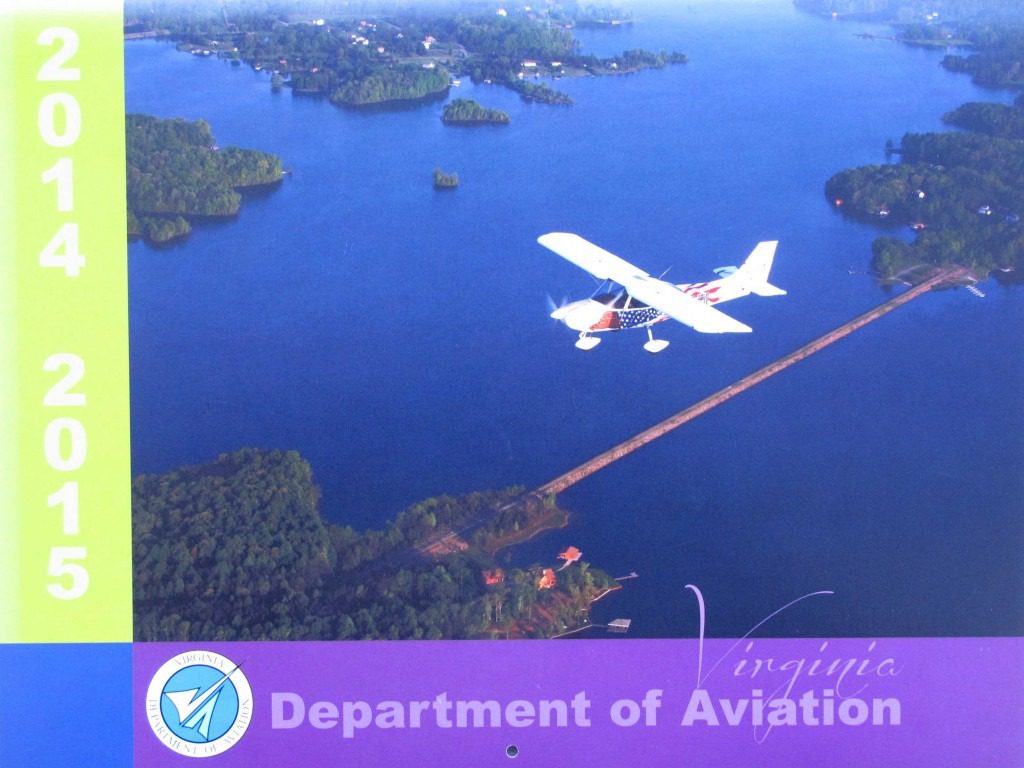 Plane flying over lake and bridge