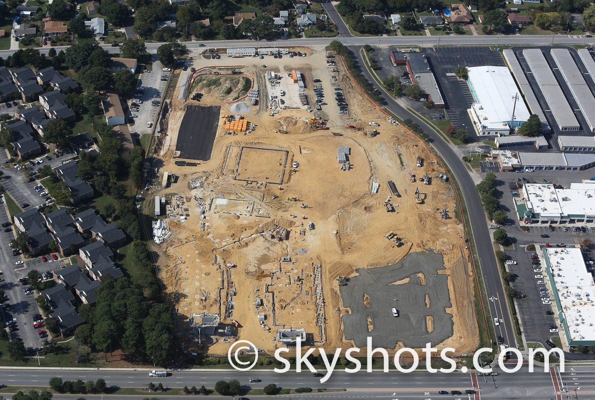 Construction site amidst urban landscape.