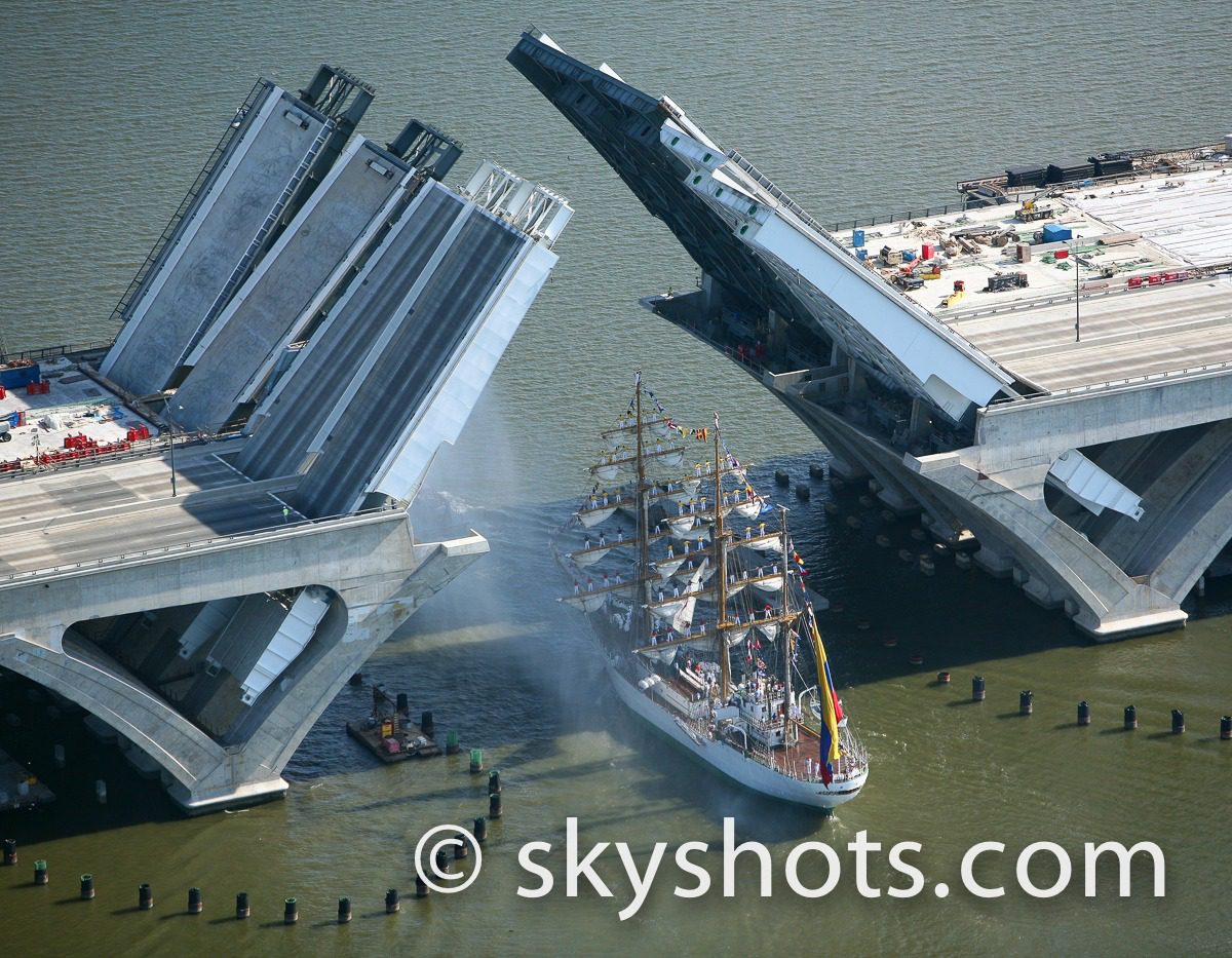 Tall ship beneath open bridge
