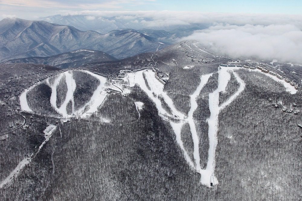 Snowy mountain ski slopes aerial view
