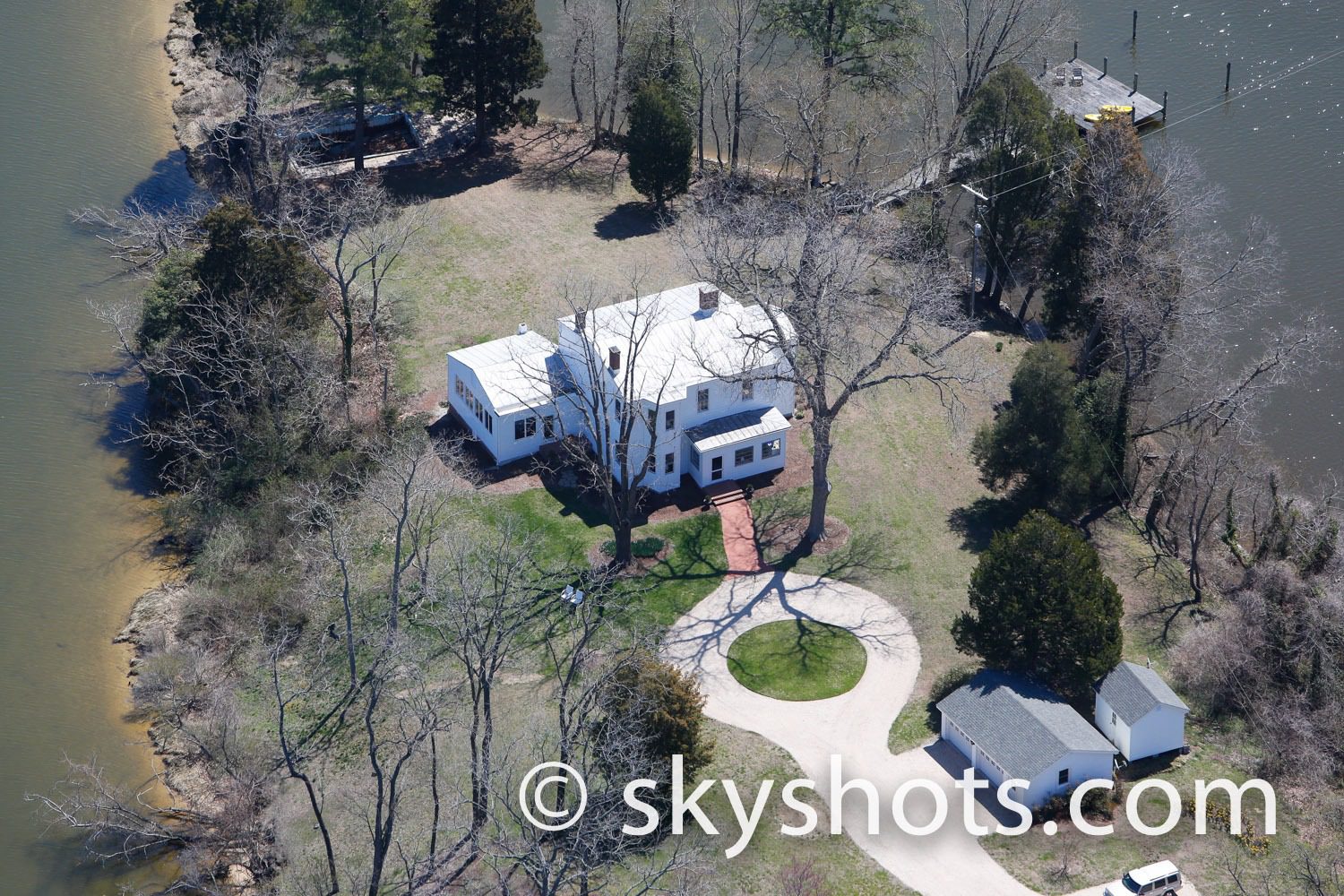 House near water surrounded by trees