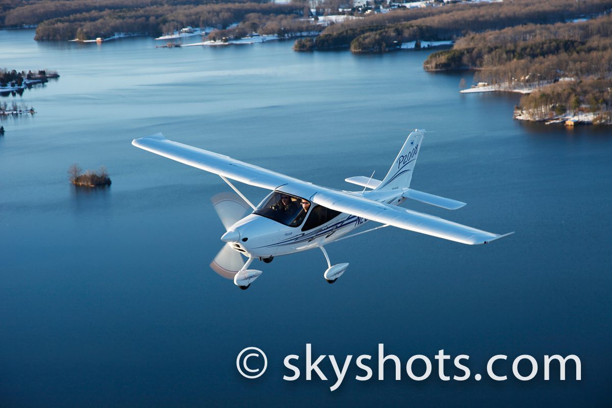 Light plane in flight over landscape
